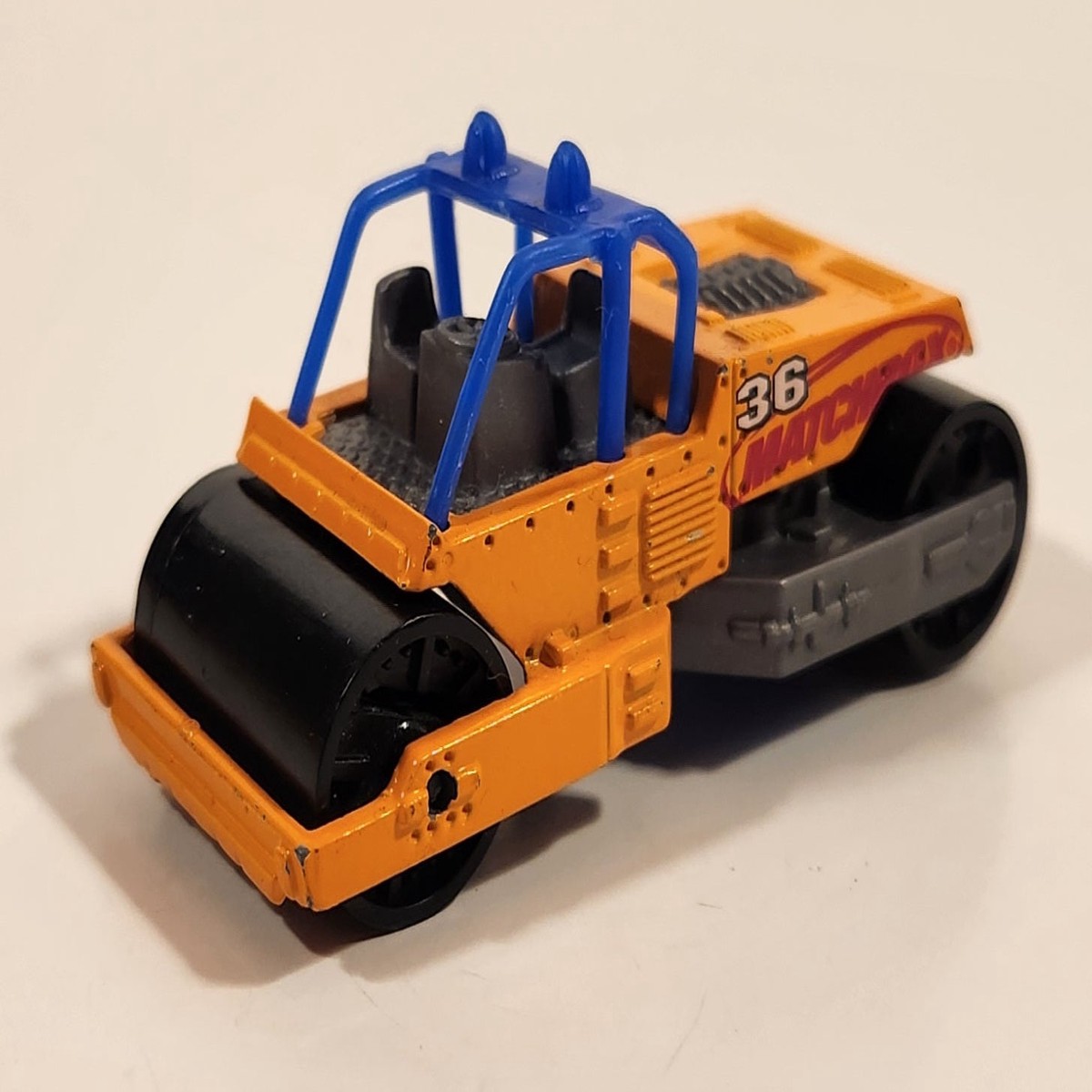 2000 Matchbox Earth Crunchers Road Roller Fluorescent Orange Die Cast Toy Construction Vehicle
