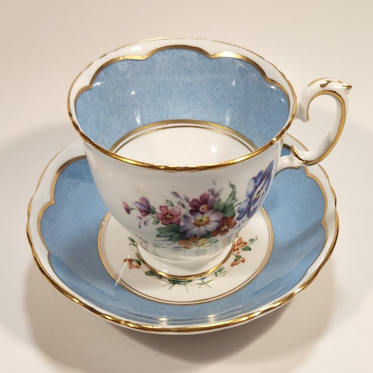 Vintage Crown Fine Bone China Staffordshire England Mixed Flower Pattern Blue and White Gold Trim Tea Cup Saucer